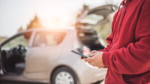 calling roadside assistance on the side of the road