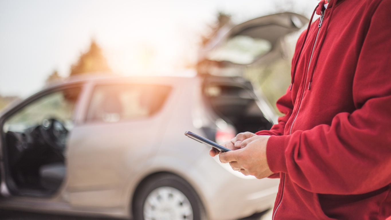 calling roadside assistance on the side of the road